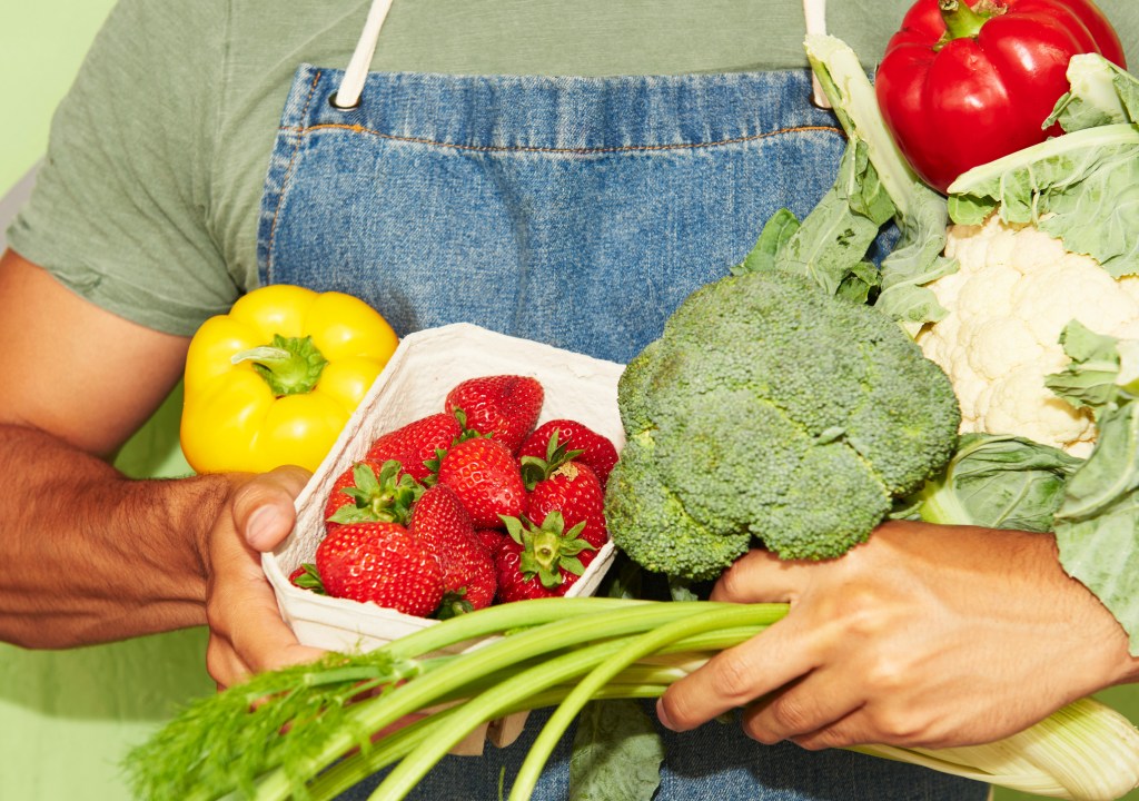 Close up of man holding fresh vegetables -