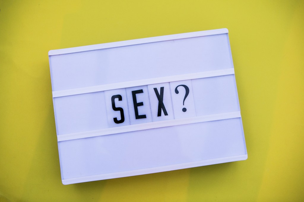 sex word written in lightbox yellow background -